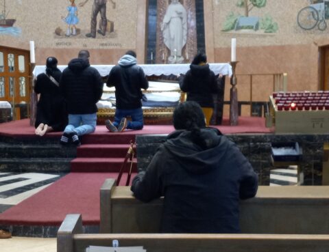 people kneeling before an altar
